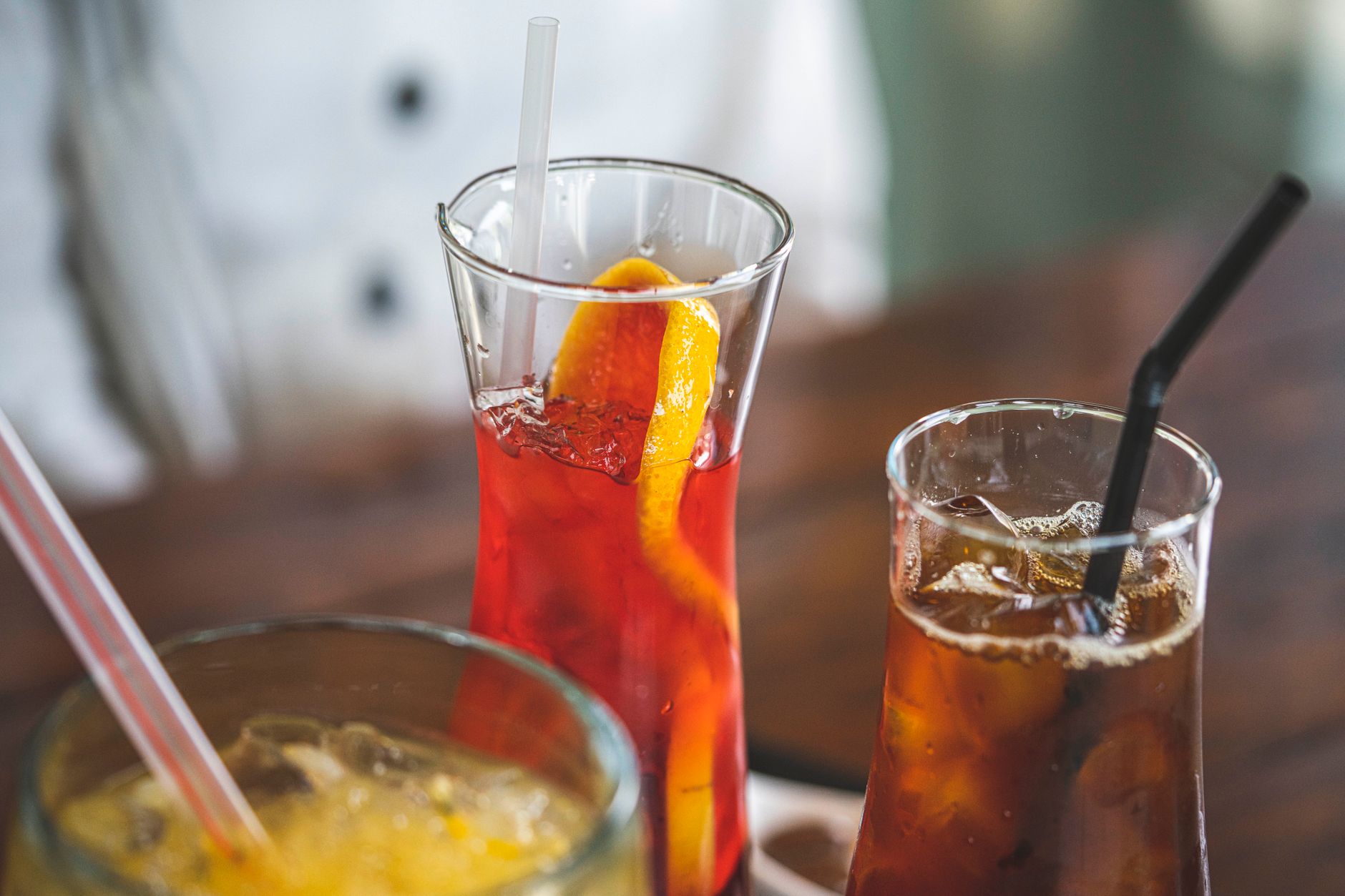 Sugar-sweetened drinks with ice and straws on a table