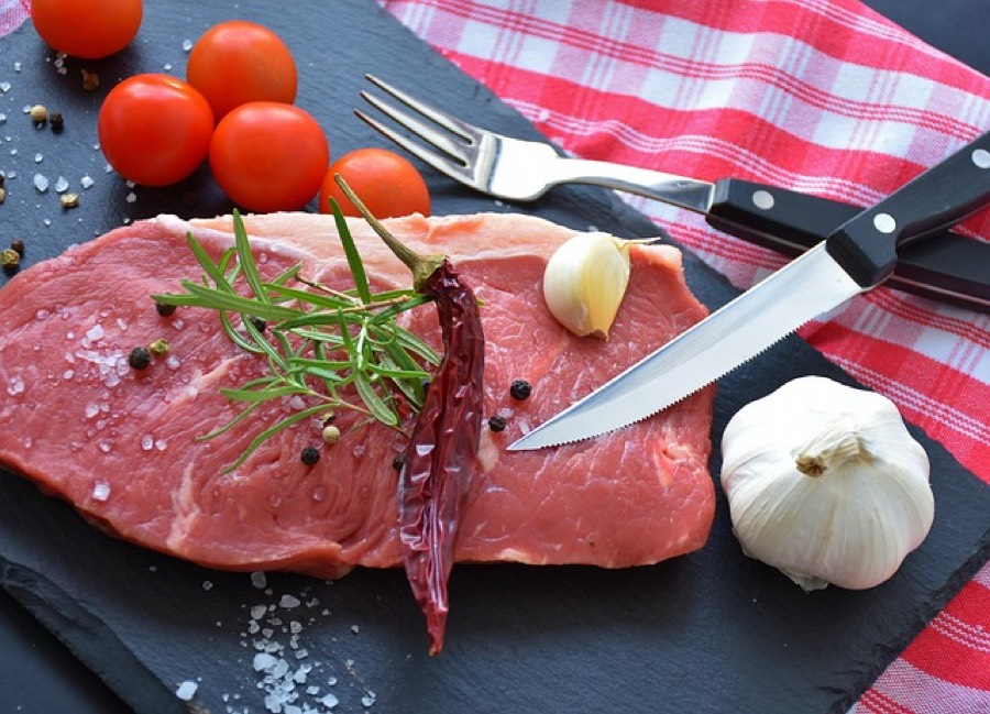 Raw beef steak on a slate board