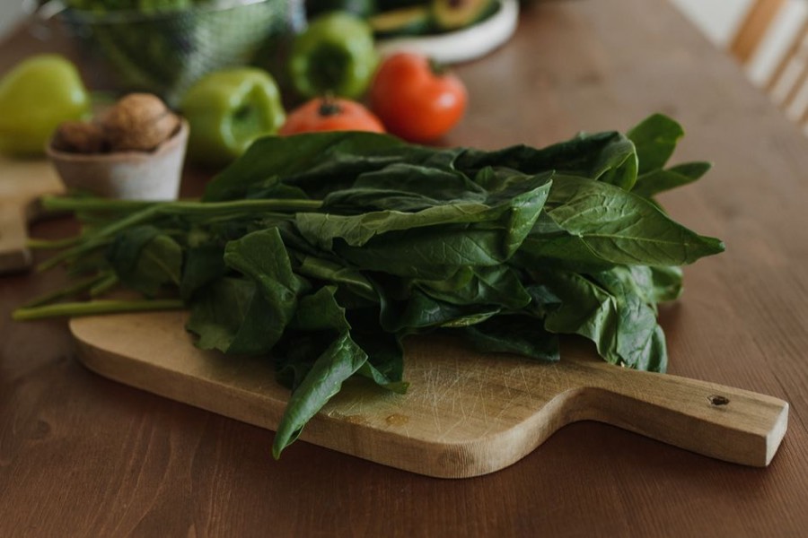 Fresh spinach leaves on a wooden chopping board
