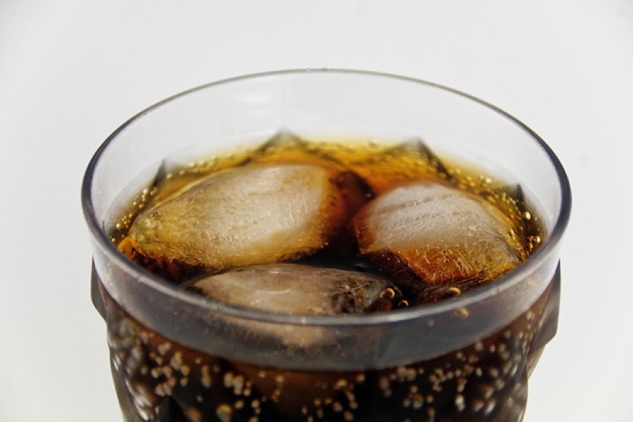 A glass of cola with ice cubes