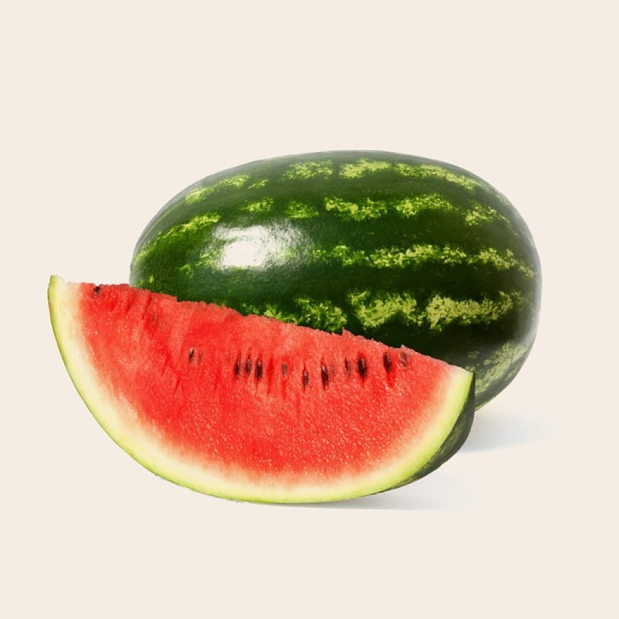 A whole watermelon with a fresh red wedge cut from it