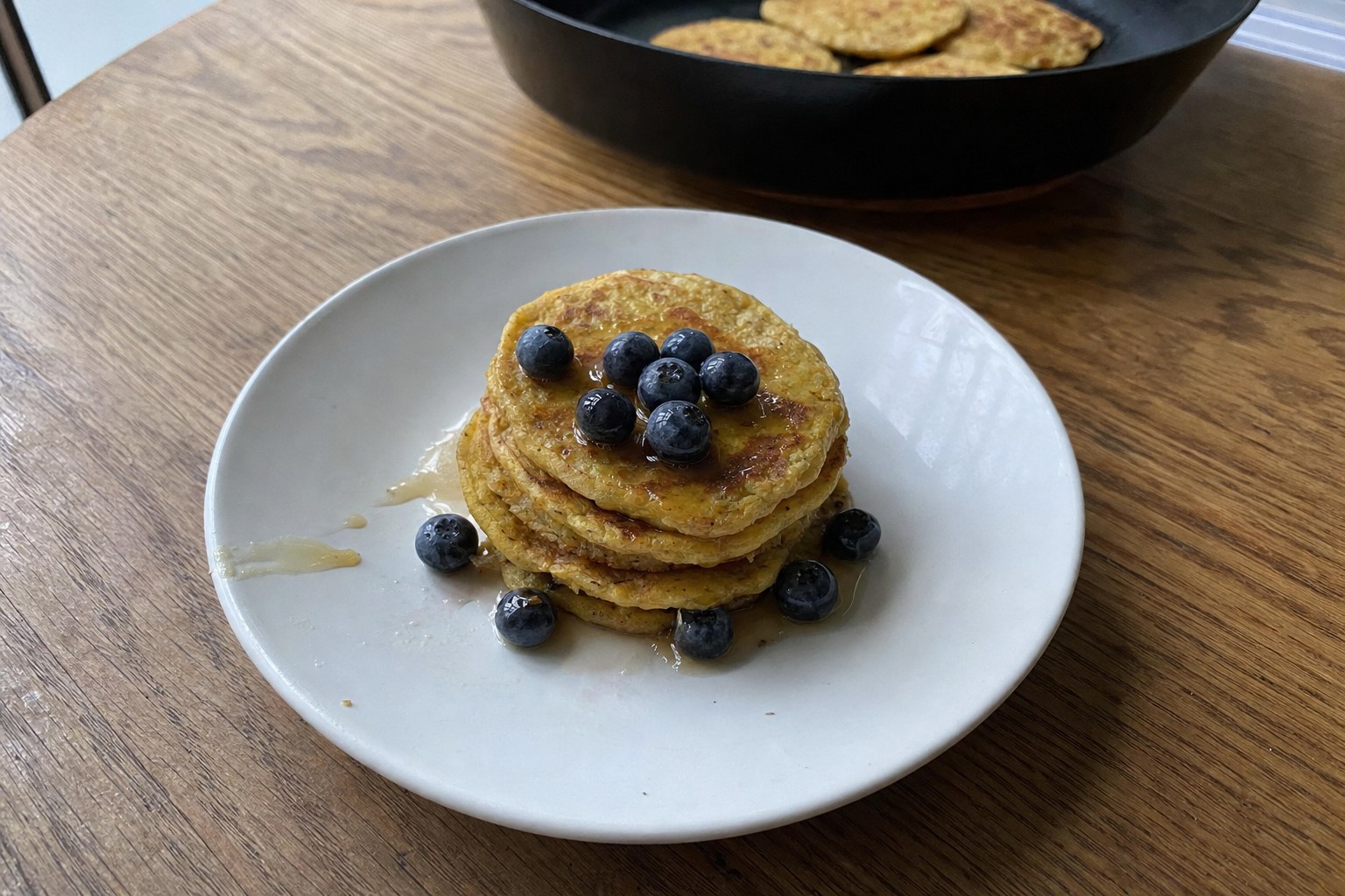 AIP green plantain pancakes with blueberries, maple syrup and cinnamon