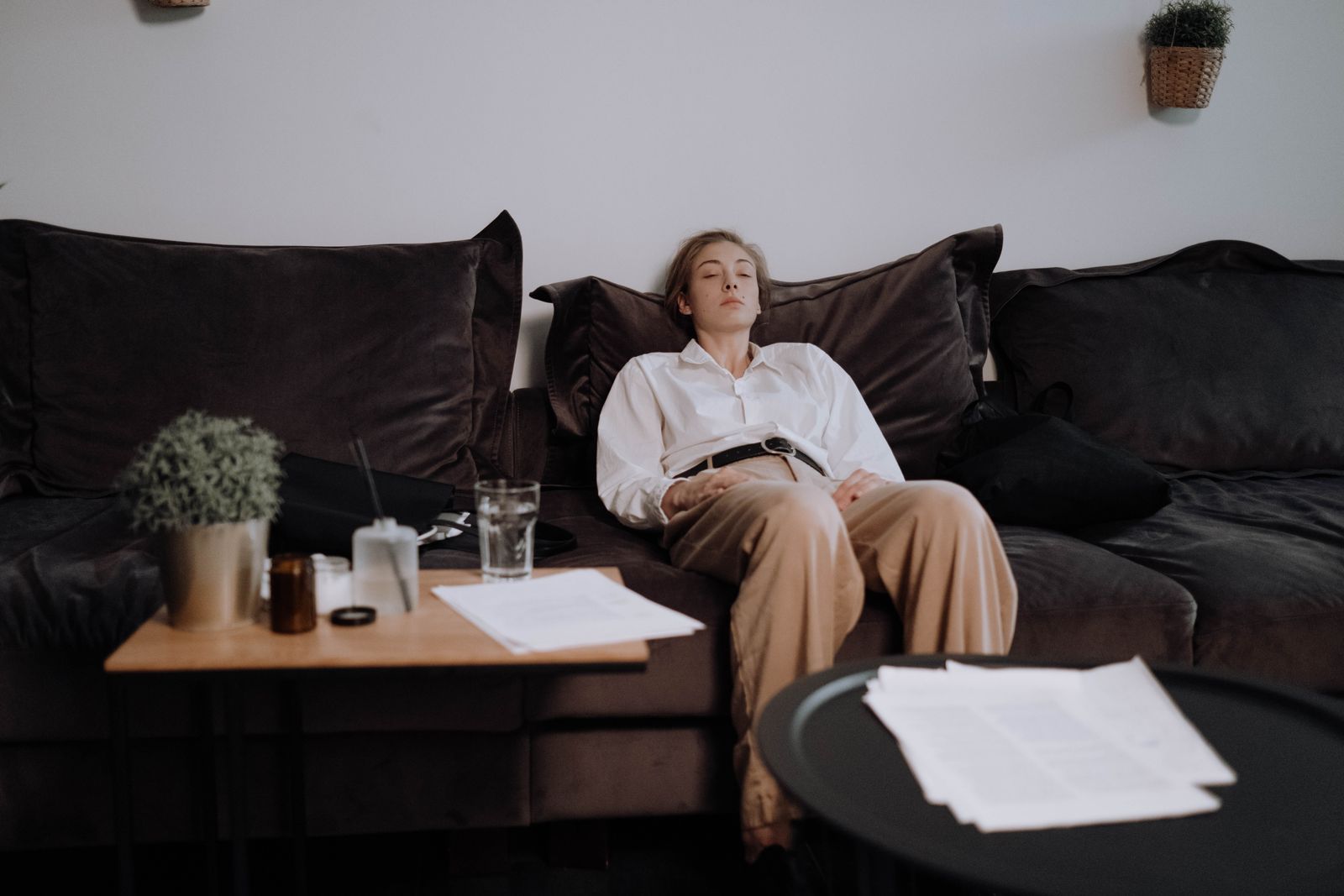 Exhausted woman resting on a sofa at the end of the day